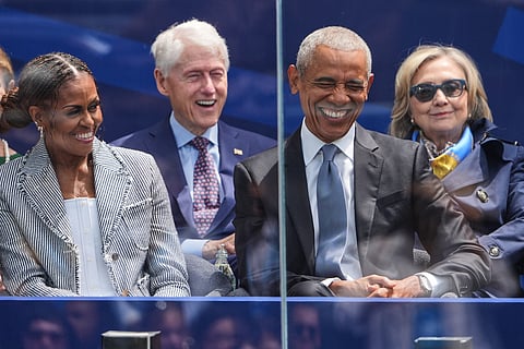 Former President Barack Obama, right, shares a laugh with former first lady Michelle Obama, left, on stage during the dedication ceremony for the Obama Presidential Center, Thursday, June 18, 2026, in Chicago