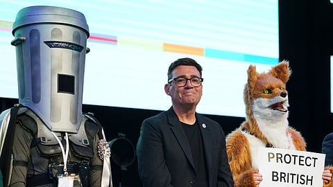 Labour Party's Andy Burnham stands beside candidate Count Binface, left, and a candidate for Protect British Wildlife after winning the Makerfield by-election, paving the way for a leadership challenge against Prime Minister Sir Keir Starmer in Wigan, England, Friday, June 19, 2026.