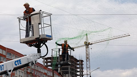 Municipal workers install anti drone nets to prevent Russian attacks on people and transport in Zaporizhzhia, Ukraine, Thursday, June 18, 2026. 