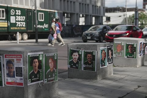 Posters of missing people wearing Mexican national soccer team jerseys to resemble World Cup sticker album cards are posted on a street in Guadalajara, Mexico, Tuesday, June 16, 2026. 