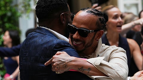 Lewis Hamilton, right hugs Colman Domingo as he arrives for the Ralph Lauren Spring/Summer 2027 men's collection.