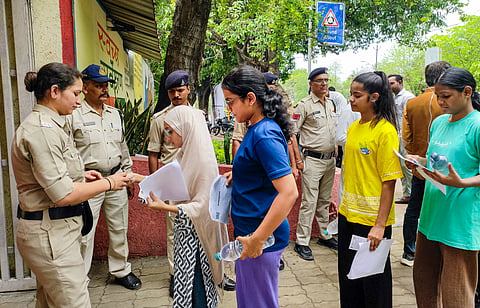 NEET-UG aspirants queue up for verification before entering an examination centre to appear for the NEET-UG 2026 re-examination, in Bhopal, Sunday, June 21, 2026.