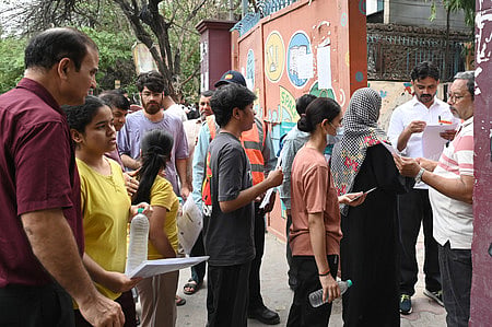 NEET-UG candidates undergo security screening before entering an examination centre, in New Delhi, Sunday, June 21, 2026.