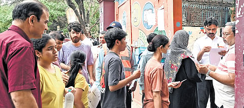Candidates undergo security screening before entering exam centre 