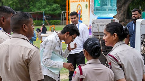 A NEET-UG candidate drinks water at an examination centre amid security arrangements, in New Delhi, Sunday, June 21, 2026. The Re-NEET UG 2026 examination is being conducted following the cancellation of the original test held on May 3 amid a paper leak controversy.