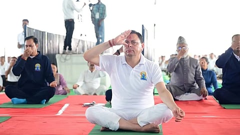 Chief Minister Pushkar Singh Dhami doing yoga during the state-level International Yoga Day programme in Dehradun 