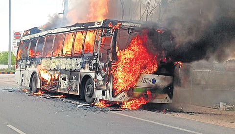 An electric bus engulfed in flames on Rajiv Rahadari in Karimnagar.