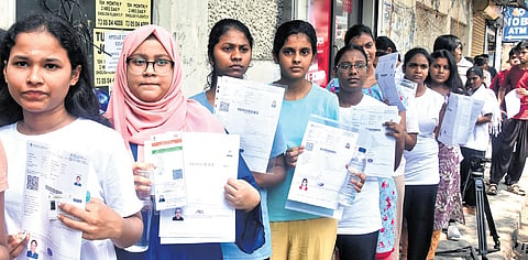Students queue up outside The New College centre in Chennai as they await entry for the NEET re-examination on Sunday.