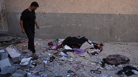 A Palestinian man inspects the rubble of the apartment of the Safadi family in Gaza City, Saturday, June 20, 2026, following an overnight Israeli airstrike.