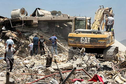 An excavator clears rubble from the site of a collapsed building, following Israeli bombardment in Nabatieh,  in southern Lebanon on June 21, 2026.