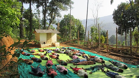 Tribal residents of Kozhiyalakudi in Mankulam practising yoga.
