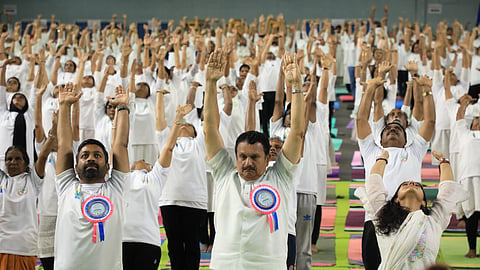 Kerala Health Minister K Muraleedharan participates in a mass yoga session during the International Day of Yoga celebrations at Jimmy George Indoor Stadium on Sunday.