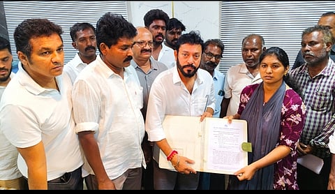 Fisheries and Fishermen welfare Minister A Srinath distributing a temporary job order to the wife of the deceased seafarer U Nishanth (35). 