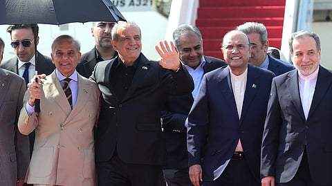 Iran's President Masoud Pezeshkian, second left, waves as he walks with Pakistan's President Asif Ali Zardari, second right, and Prime Minister Shehbaz Sharif, left, upon his arrival at Nur Khan airbase in Rawalpindi, Pakistan, on Tuesday, June 23, 2026.