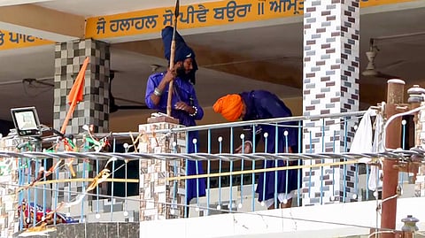A group of Nihang Sikhs arrive at the Gurdwara at Nagrasu in Rudraprayag to persuade the Nihangs staying inside to comply, Tuesday, May 23, 2026.