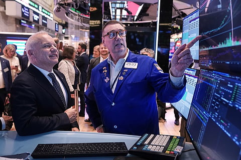 Anders Opedal, President and CEO of Norway's Equinor, left, meets with specialist Patrick King on the floor of the New York Stock Exchange, after he rang the closing bell, Tuesday, June 16, 2026. 
