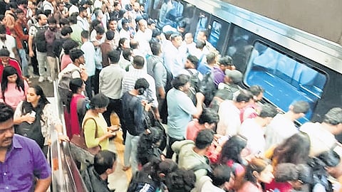 Commuters at the Cubbon Park Metro Station in Bengaluru after services were disrupted on Tuesday.