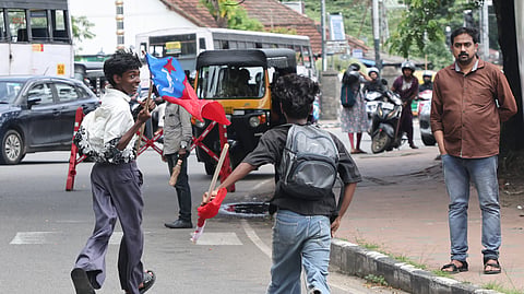  Two protesters run to escape a police water cannon as AIYF and AISF activists stage a joint Legislative Assembly protest against the state government's education policies Monday.