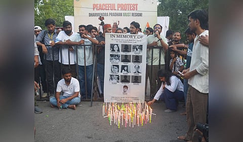 CJP supporters light candles for students who allegedly died by suicide following paper leak.