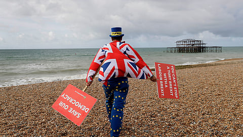 Anti-Brexit campaigner Steve Bray walks on the beach to pose for a photograph during the Labour Party Conference at the Brighton Centre in Brighton, England, Monday, Sept. 23, 2019.
