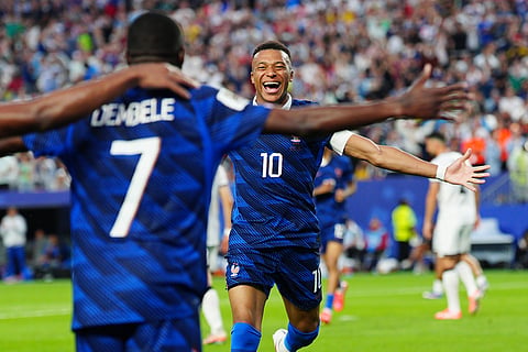 France's Ousmane Dembele (7) celebrates with Kylian Mbappe (10) after scoring their third goal during the World Cup Group I soccer match between France and Iraq in Philadelphia, Monday, June 22, 2026.