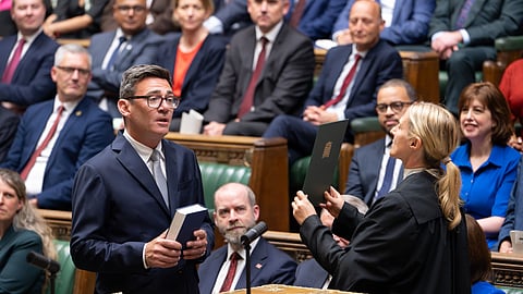 Andy Burnham, front left, is sworn-in as an MP in the House of Common in London, England, Monday, June 22, 2026.