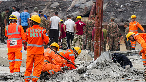  Officials and others gather during a rescue operation after a three-storey under-construction warehouse collapsed at Taratala area, in Kolkata, West Bengal, Wednesday, June 24, 2026.