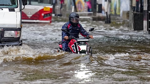  A commuter navigates a waterlogged road after heavy rainfall inundates several parts of the city, in Mumbai, Maharashtra, Wednesday, June 24, 2026.
