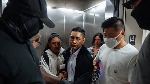 FILE - Immigration and Customs Enforcement agents pull a man out of an elevator as he and his daughter attempt to leave following a hearing in immigration court, Friday, Sept. 5, 2025, in New York.