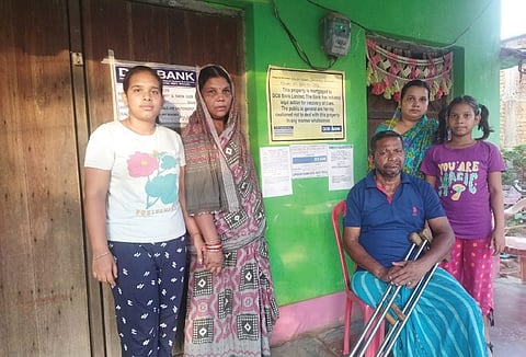 The 62-year-old man with his family in front of their house 