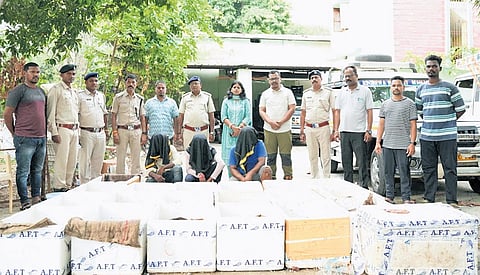 Forest dept officials with the accused and the boxes in Malkangiri.