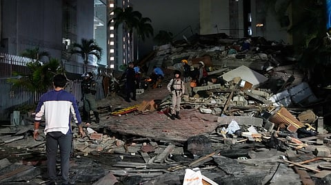 People walk amid debris after an earthquake in Caracas, Venezuela, Wednesday, June 24, 2026. 