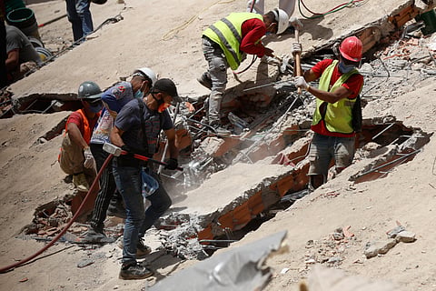 Rescue worker search through the rubble of a collapsed building two days after earthquakes struck Caracas, Venezuela, Friday, June 26, 2026.