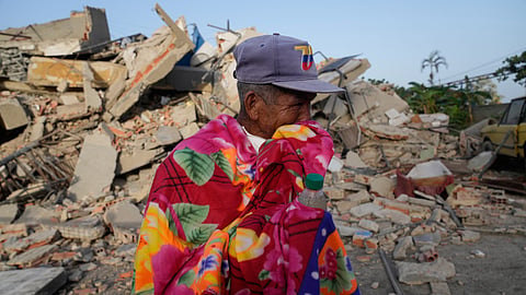 A man stands in front of a collapsed building two days after an earthquake struck La Guaira, Venezuela, Friday, June 26, 2026.