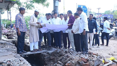 Minister Kollu Ravindra observing drainage construction works in Machilipatnam.