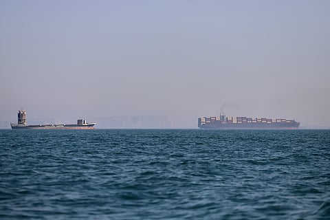 A container ship, right, and a cargo vessel are seen in the Strait of Hormuz off Bandar Abbas, Iran, Wednesday, June 17, 2026.