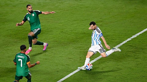 Argentina's Lionel Messi (10) shoots and scores their third goal against Algeria's Riyad Mahrez (7) and Nabil Bentaleb (19) during the World Cup Group J soccer match between Argentina and Algeria in Kansas City, Mo., Tuesday, June 16, 2026.