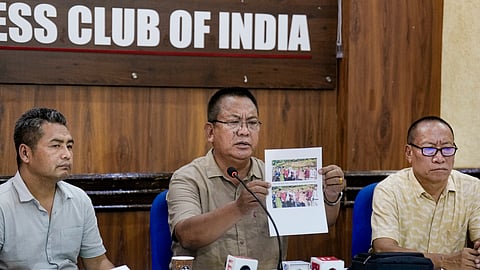  United Naga Council (UNC) leader KS Paul Leo, centre, displays photographs while addressing a press conference on the situation in Manipur at the Press Club of India, in New Delhi, Saturday, June 27, 2026.