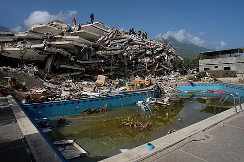 Rescue workers search through the rubble three days after earthquakes struck Catia La Mar, Venezuela, Saturday, June 27, 2026.