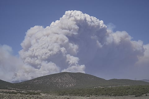 A plume of smoke rises from the Cottonwood Fire, Friday, June 26, 2026, near Beaver, Utah