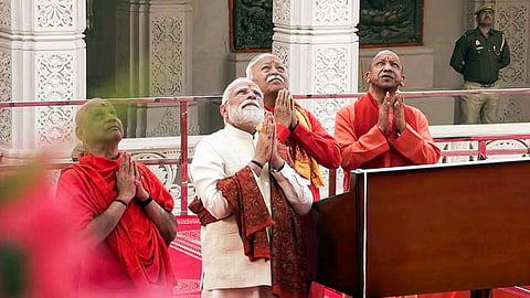 In this photo from November 25, 2026, Prime Minister Narendra Modi, Uttar Pradesh Chief Minister Yogi Adityanath and RSS Chief Mohan Bhagwat pray during the Dhwajarohan Utsav at Shri Ram Janmabhoomi Mandir in Ayodhya.