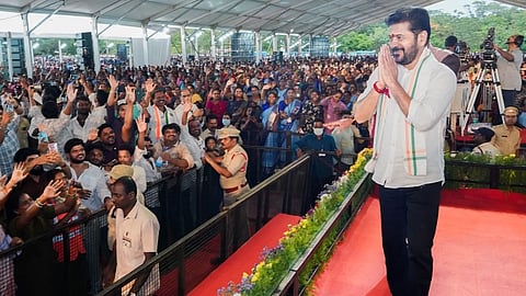 Chief Minister A Revanth Reddy greets the crowd during a public meeting at Nagarjuna Govt Degree College Grounds in Nalgonda.