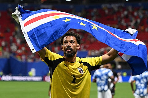Cape Verde's goalkeeper, Vozinha, celebrates with his national flag at the end of the 2026 World Cup Group H football match between Spain and Cape Verde at Atlanta Stadium in Atlanta on June 15