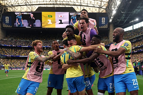 Brazil players celebrate the winning goal on Mondayh