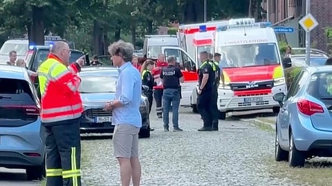 Emergency responders, residents and police in Stade, Germany, Monday, June 29, 2026 after six people were killed in a shooting on Monday at a youth welfare facility in the northern German town of Stade, police said. 