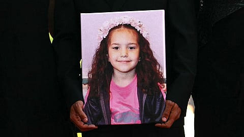 A portrait of Hind Rajab, a five-year-old Palestinian girl who was killed by the Israeli Defense Forces, held during the red carpet for the film The Voice of Hind Rajab at the Venice Film Festival, 2025