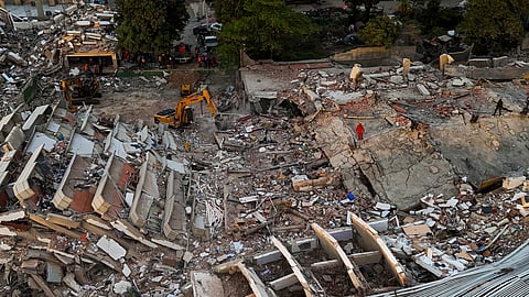This aerial view shows workers searching through destroyed buildings in Caraballeda, La Guaira State, Venezuela, on Monday, June 29, 2026, following two major earthquakes. 