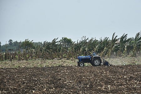 A farmer is seen levelling his field, expecting good rains 