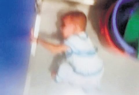 A video grab of a toddler locked inside a bathroom at the daycare centre
