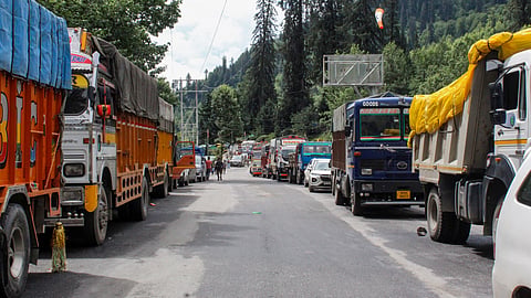 Vehicles stand stranded along the Manali-Leh National Highway in Kullu, Himachal Pradesh.
